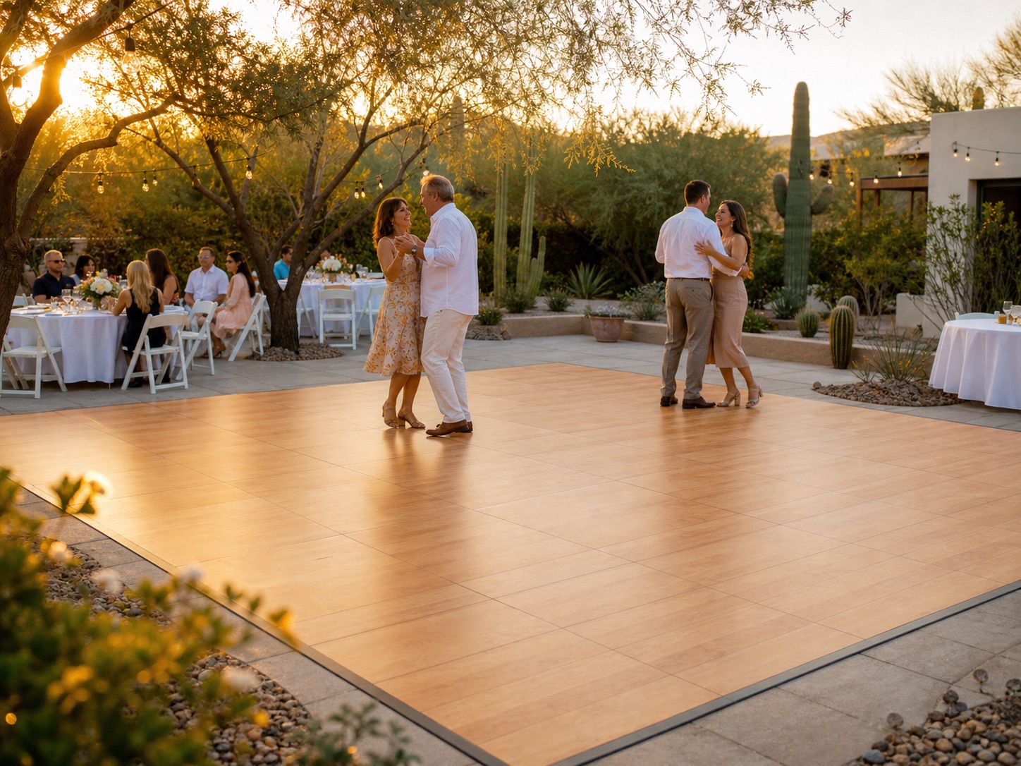 Guests dancing on a maple-look dance floor at a polished Arizona courtyard event