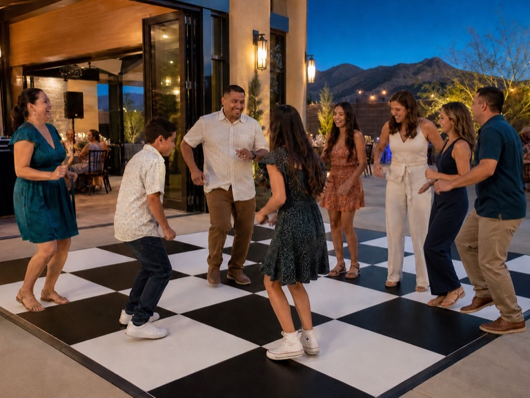 Guests enjoying a black-and-white checkered dance floor at an outdoor Arizona event